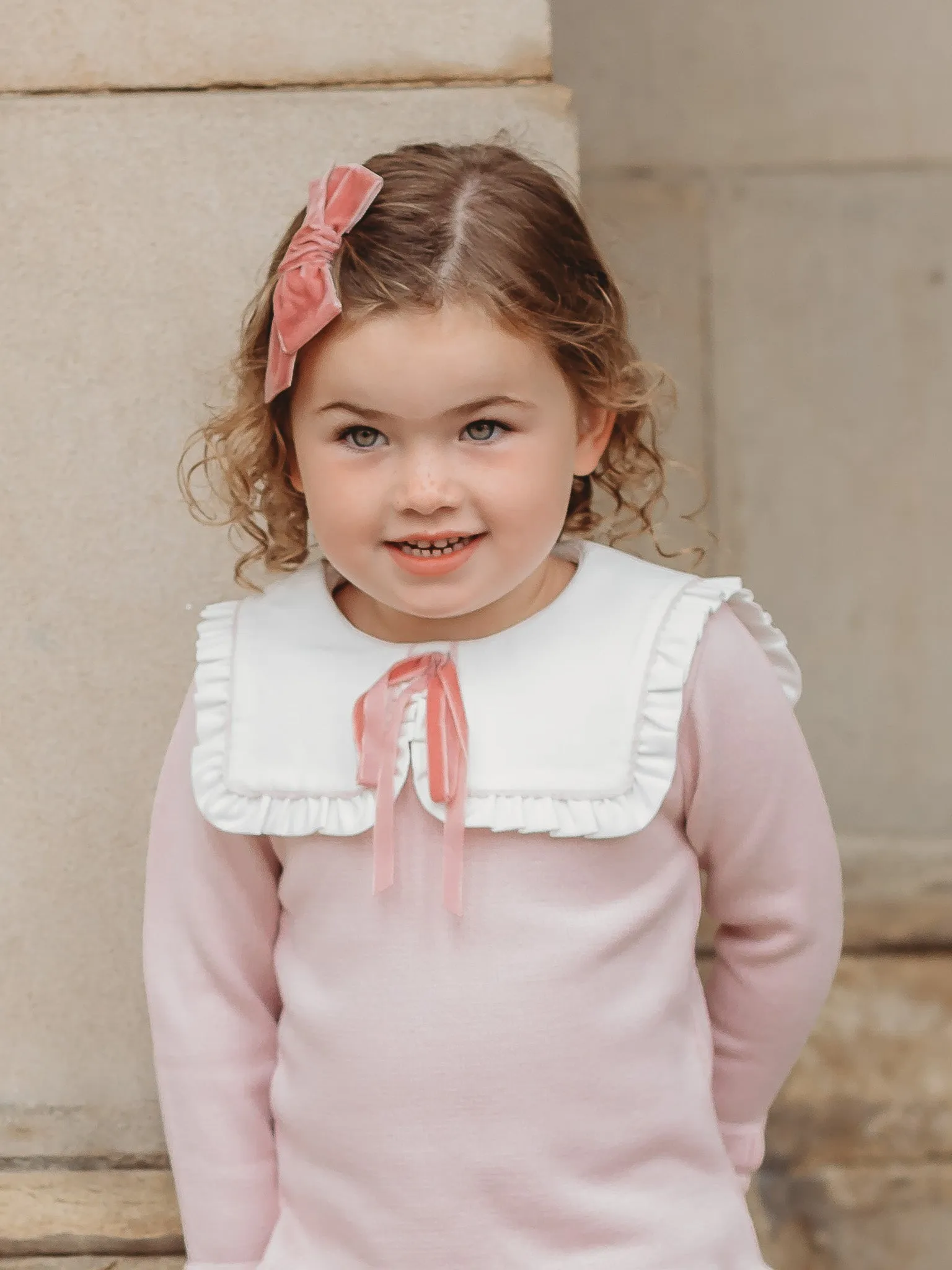 Baby Etta Pink knitted romper with bib collar