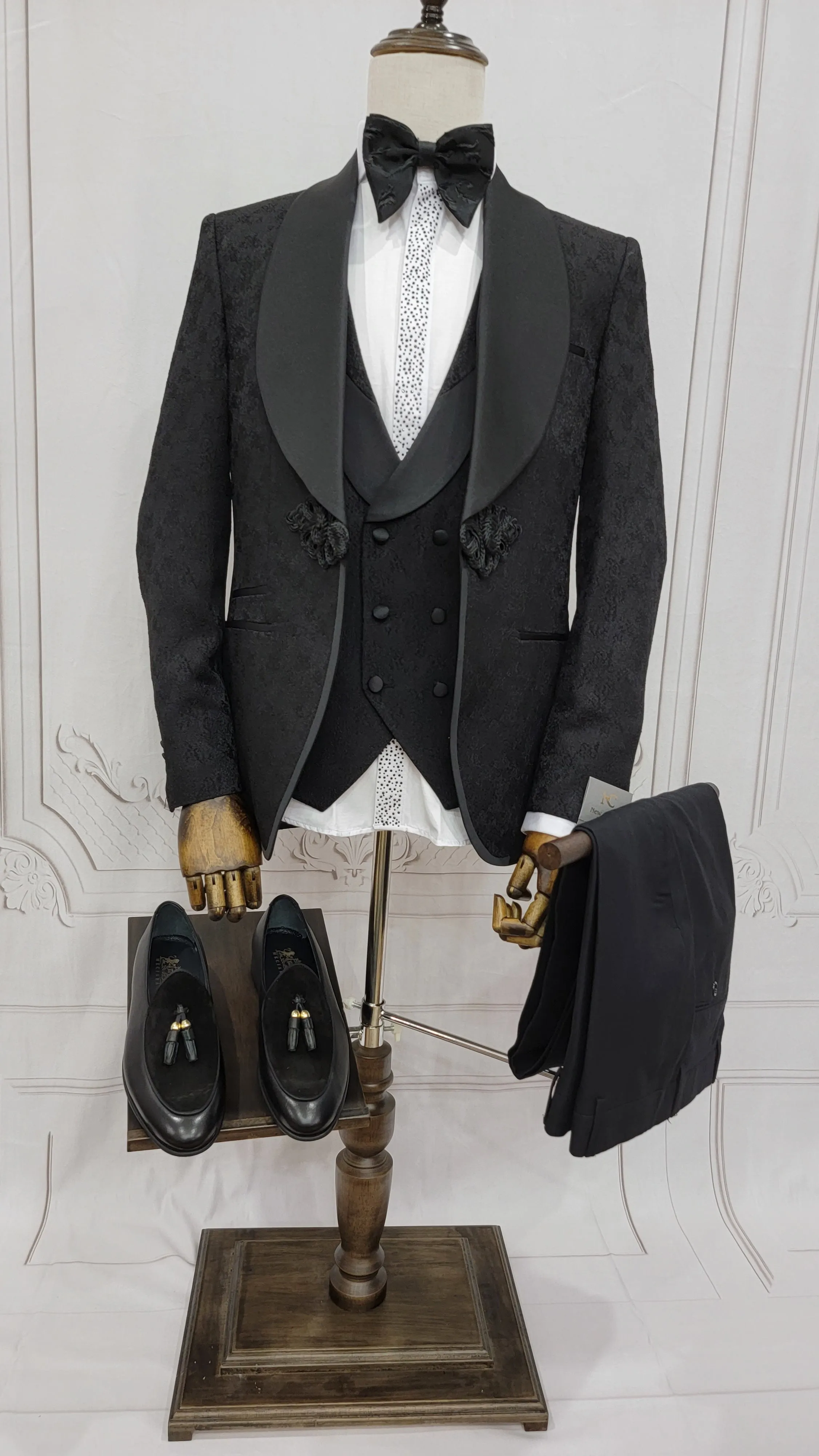 Three Piece Tuxedo Suit with Contrasting Black Satin Lapel, matching bow tie and Black Pants.