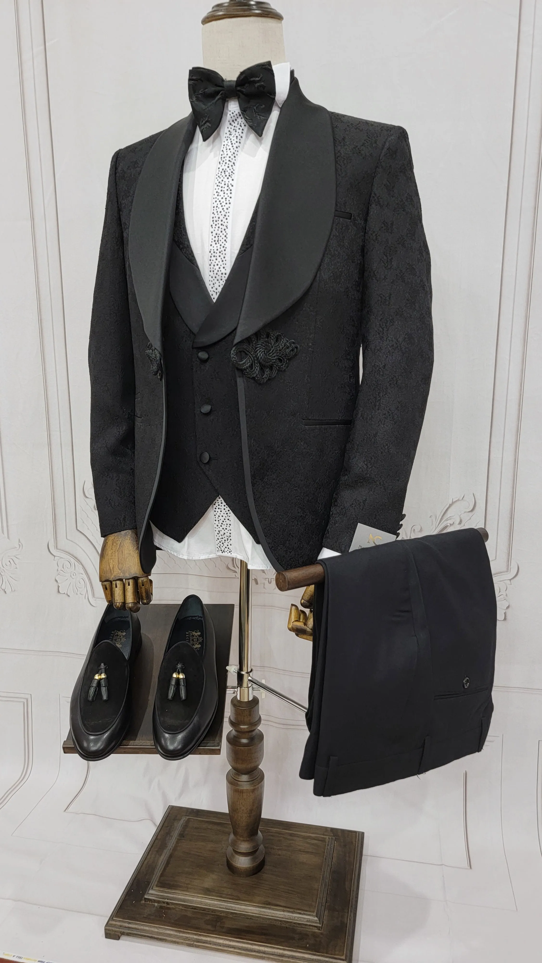Three Piece Tuxedo Suit with Contrasting Black Satin Lapel, matching bow tie and Black Pants.