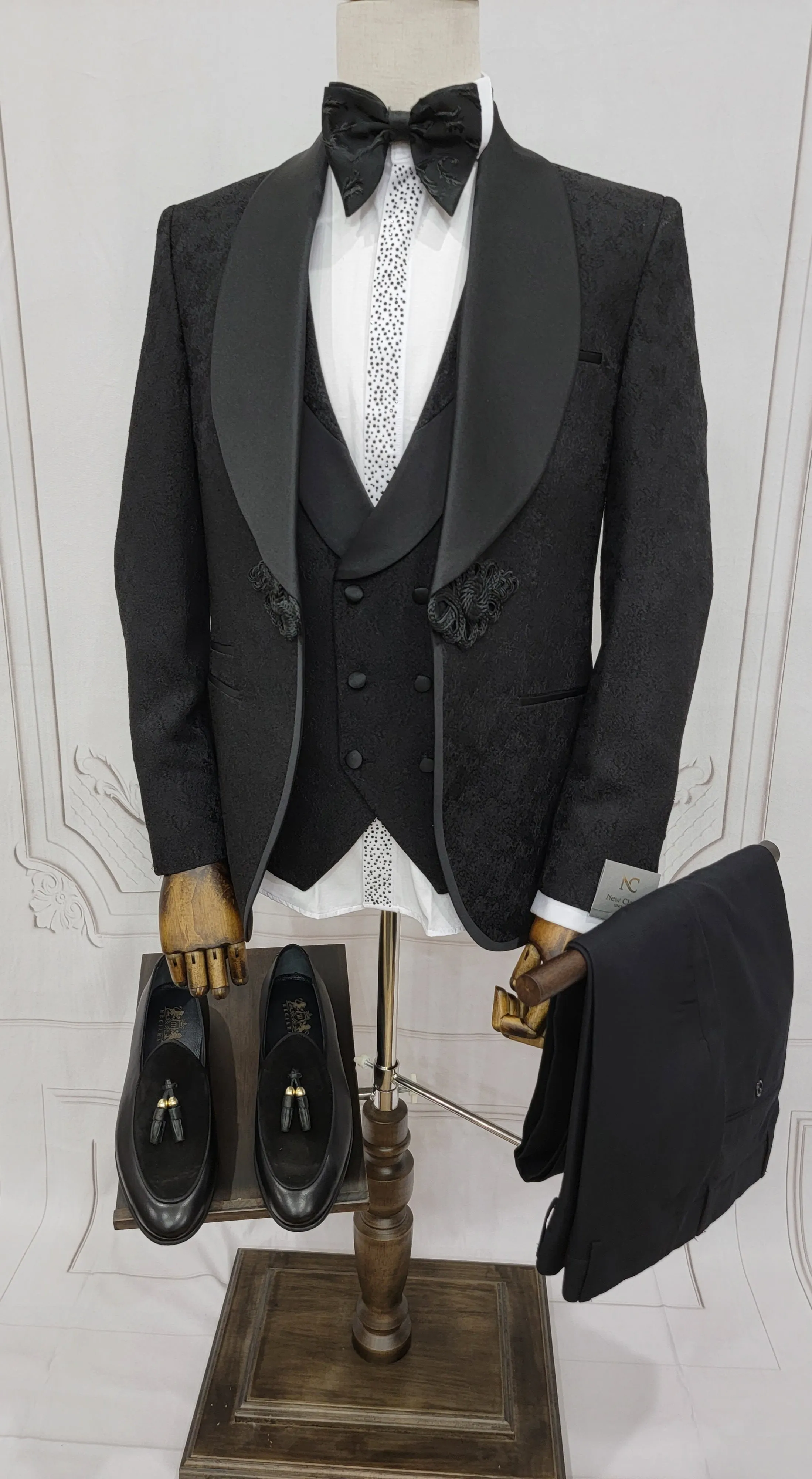 Three Piece Tuxedo Suit with Contrasting Black Satin Lapel, matching bow tie and Black Pants.