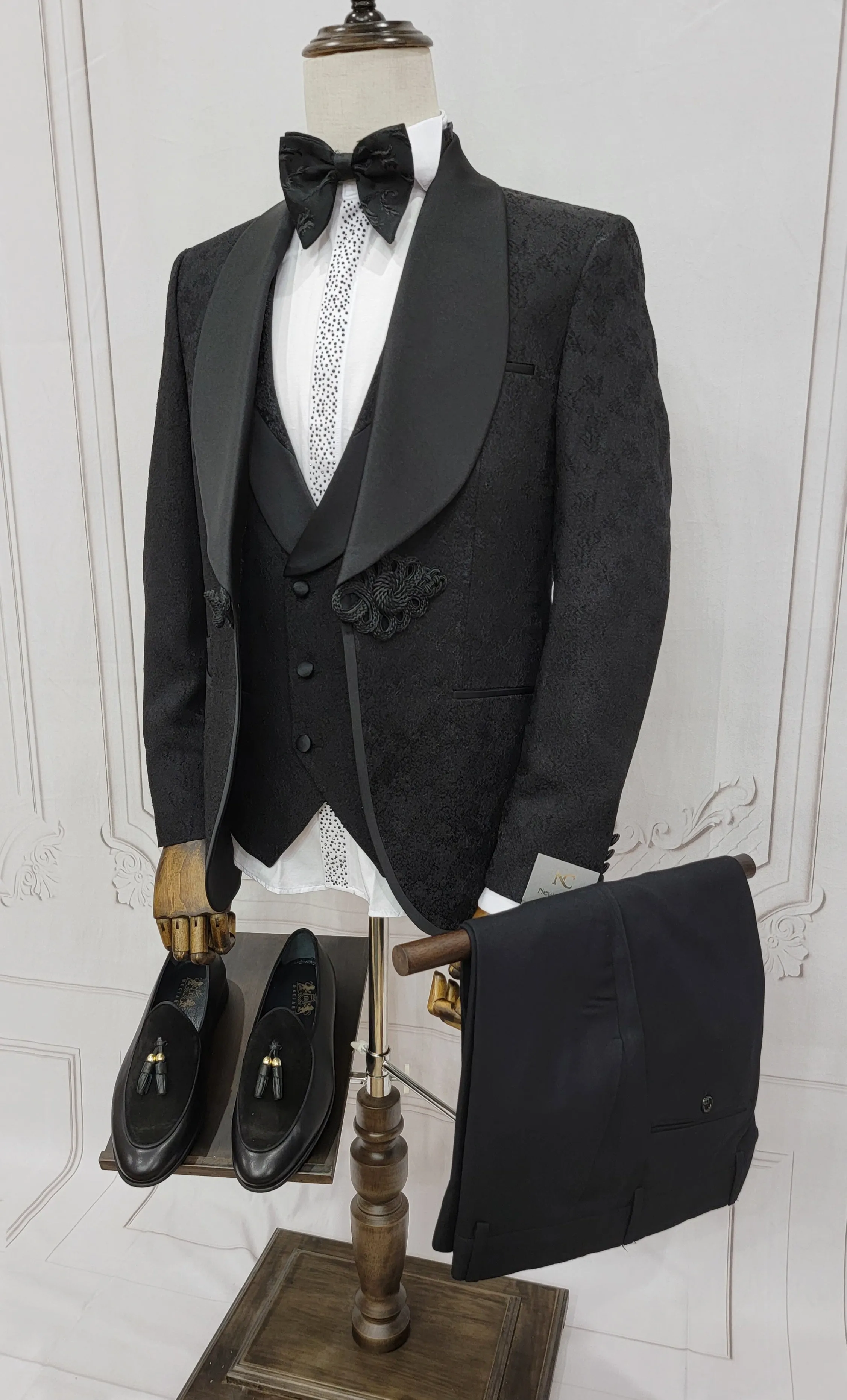 Three Piece Tuxedo Suit with Contrasting Black Satin Lapel, matching bow tie and Black Pants.