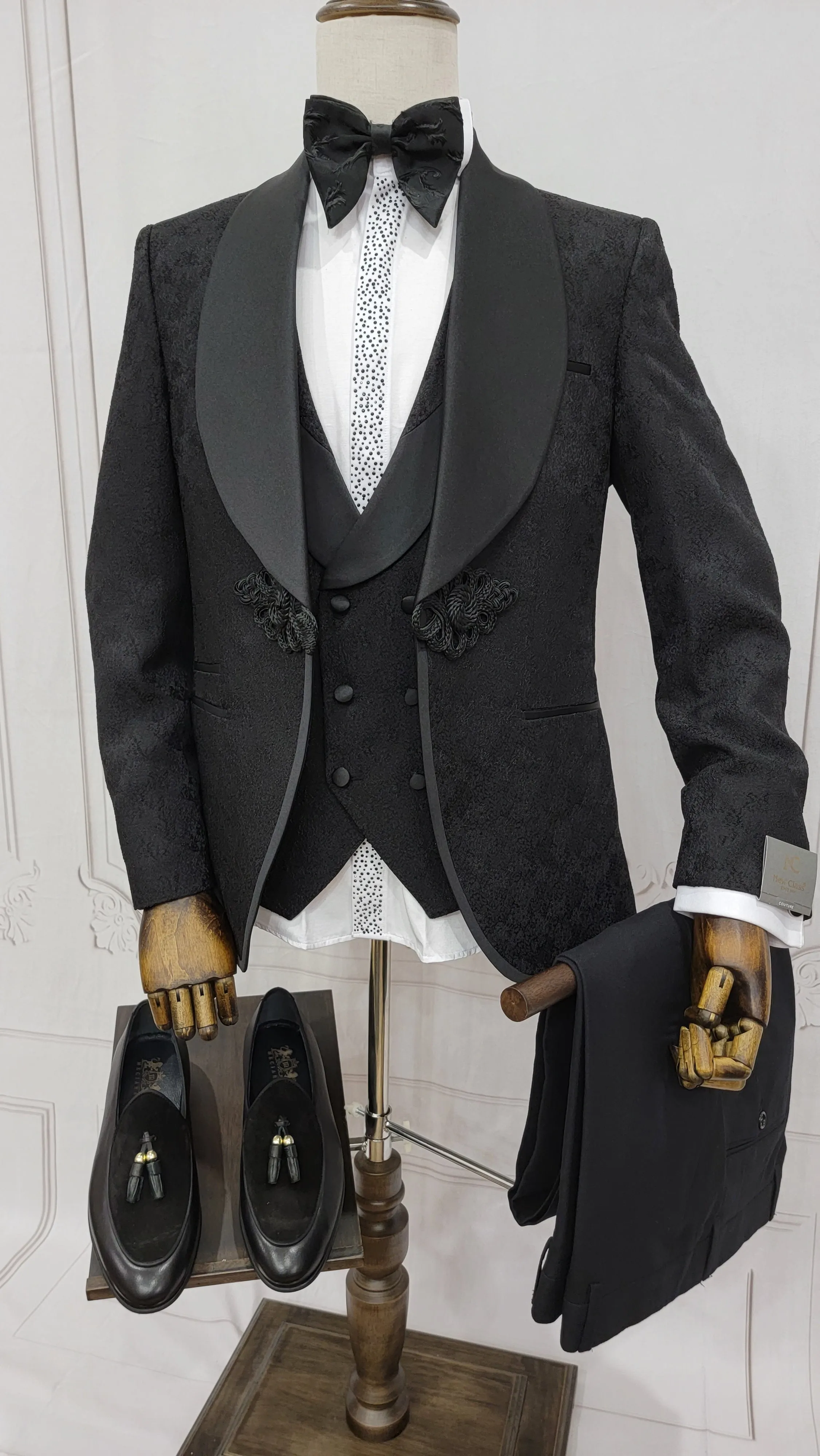 Three Piece Tuxedo Suit with Contrasting Black Satin Lapel, matching bow tie and Black Pants.