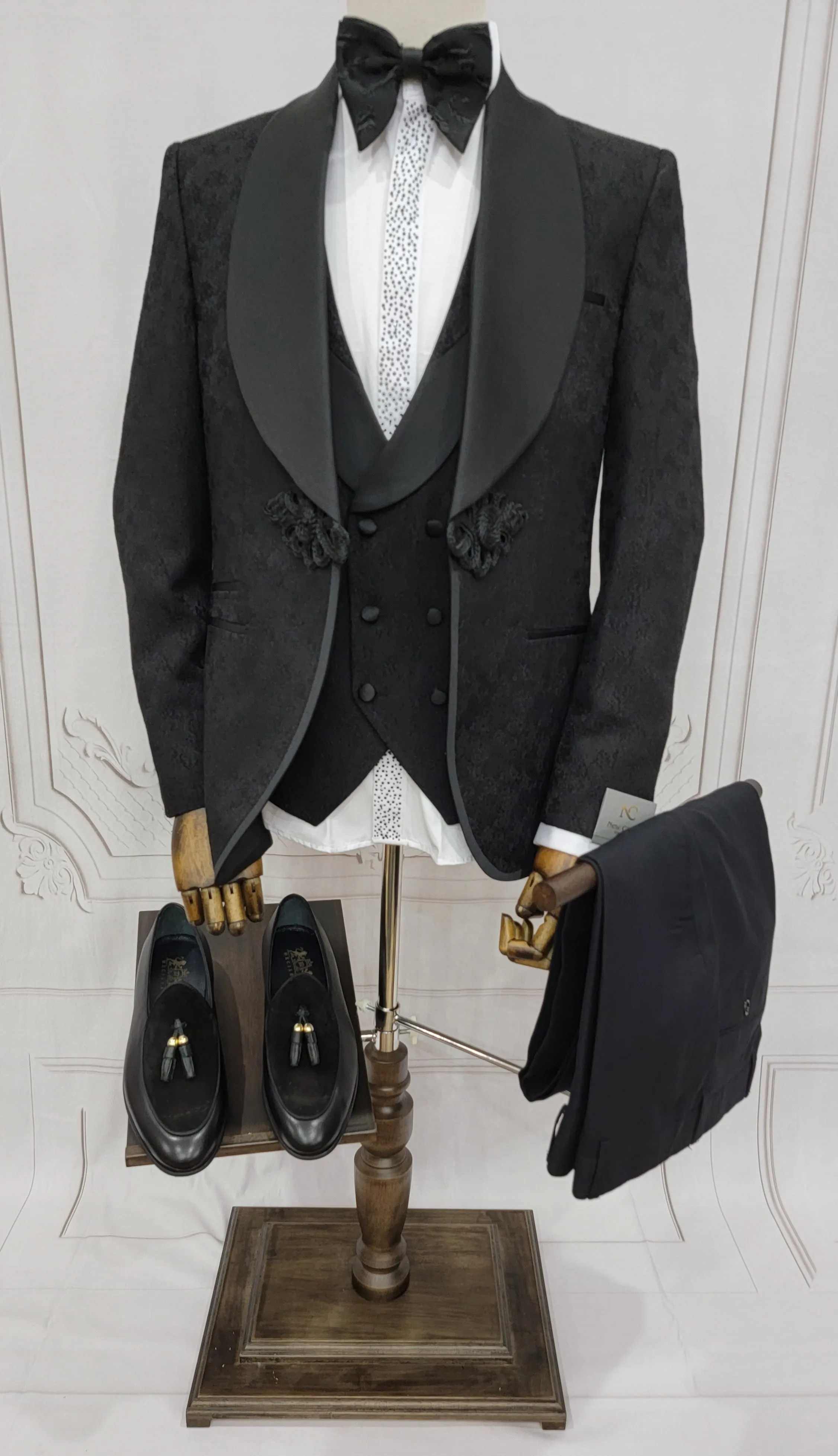 Three Piece Tuxedo Suit with Contrasting Black Satin Lapel, matching bow tie and Black Pants.